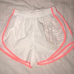 White and coral Nike shorts